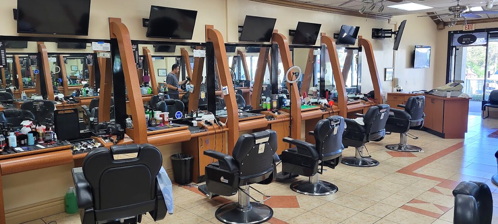 The full row of mirror stations and barber chairs running the length of the shop at Mr Cut