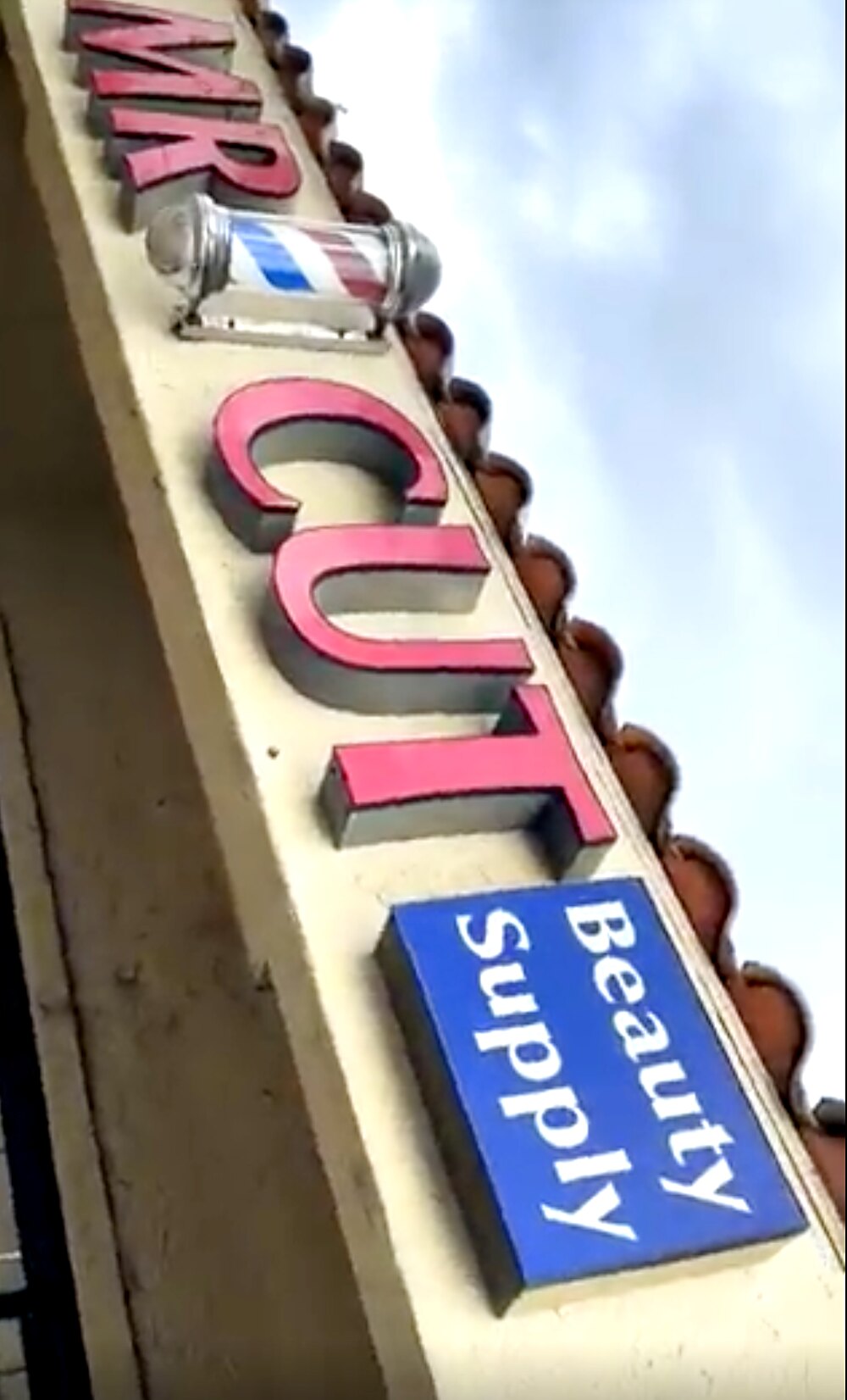 The Mr Cut sign on Jamacha Road: red channel letters, a barber pole, and the blue Beauty Supply panel
